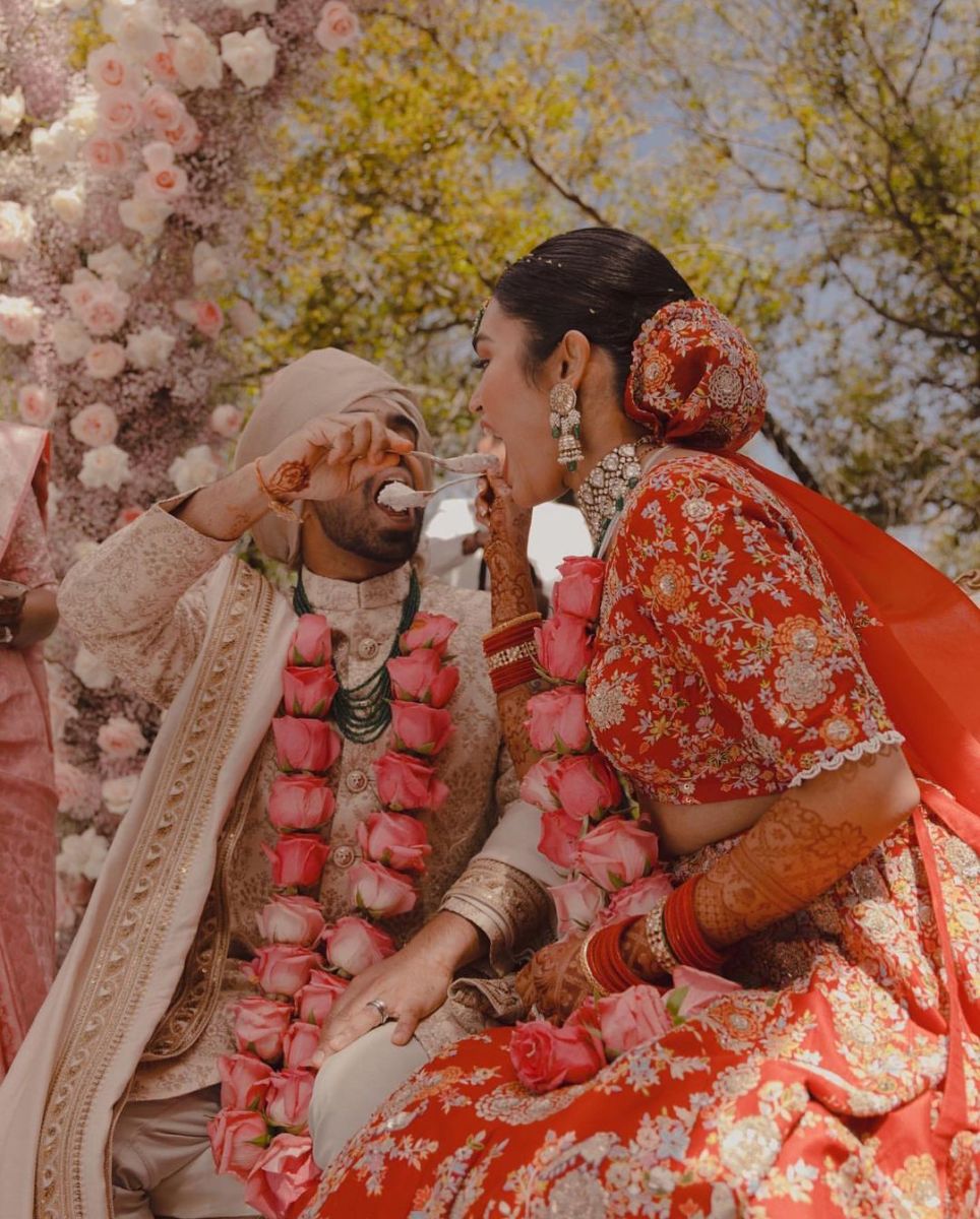 Photo of simple home wedding in red and white lehenga and green jaimala